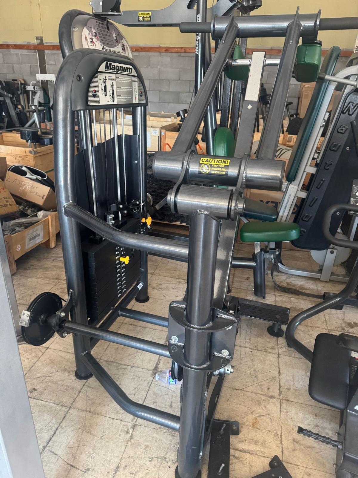 a weight training machine in a gym, with various other exercise equipment visible in the background.