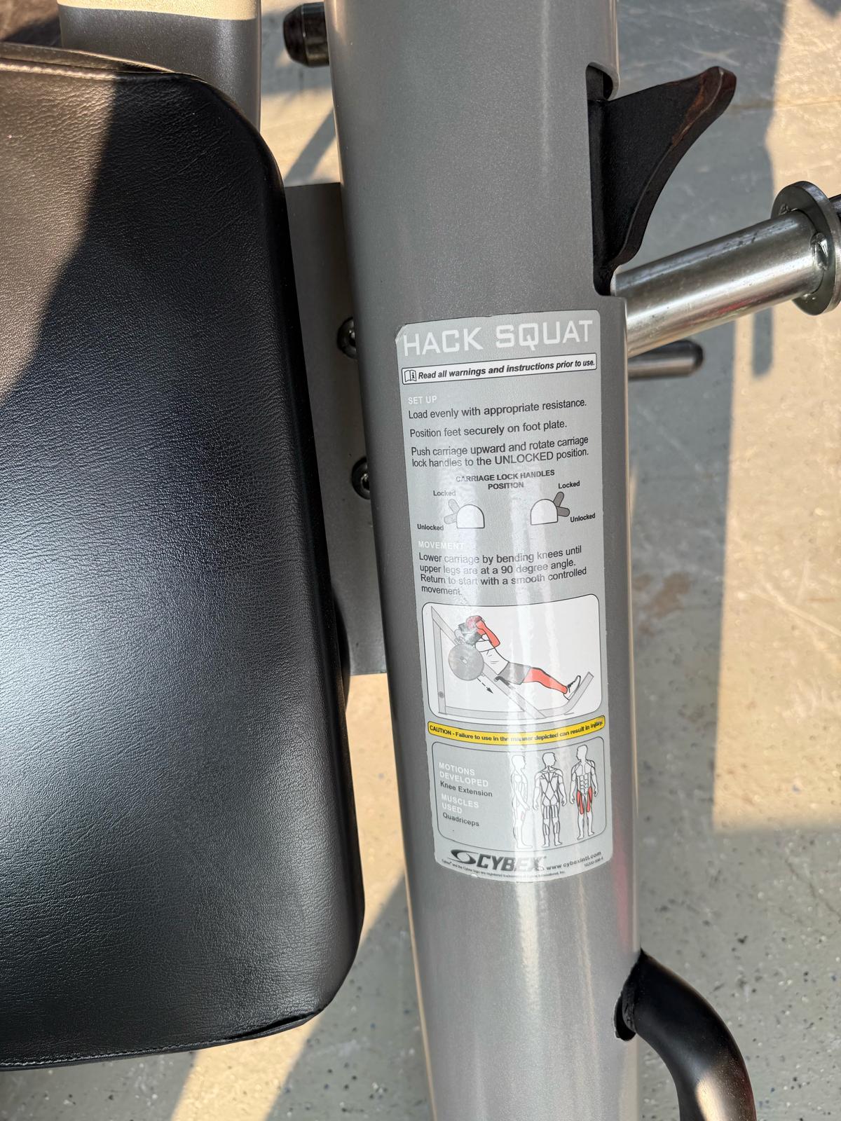 a close-up view of a black exercise machine with a label that provides instructions on how to use the machine.