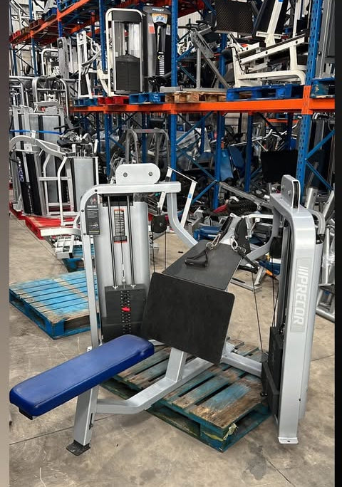 a collection of exercise equipment, including a dual row machine, in a warehouse setting.