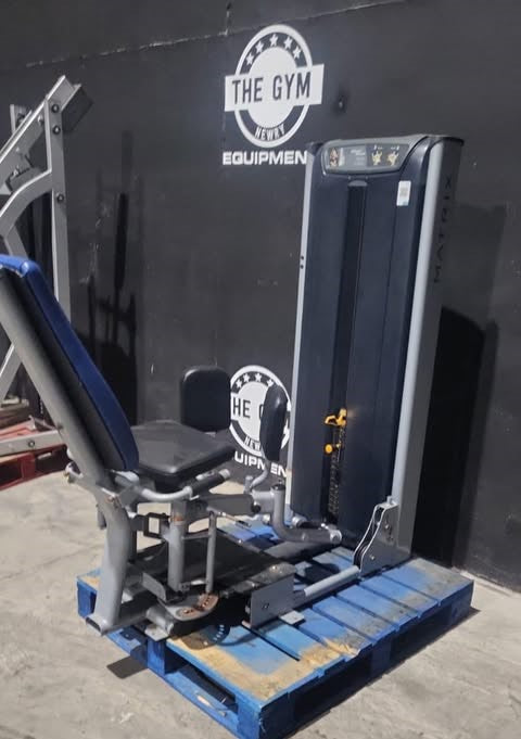 a piece of exercise equipment, specifically a weight machine, placed on a blue pallet in a gym setting.