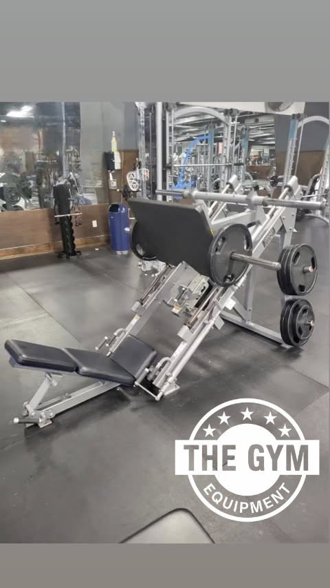 a well-equipped gym with various exercise equipment, including a weight machine and a bench.