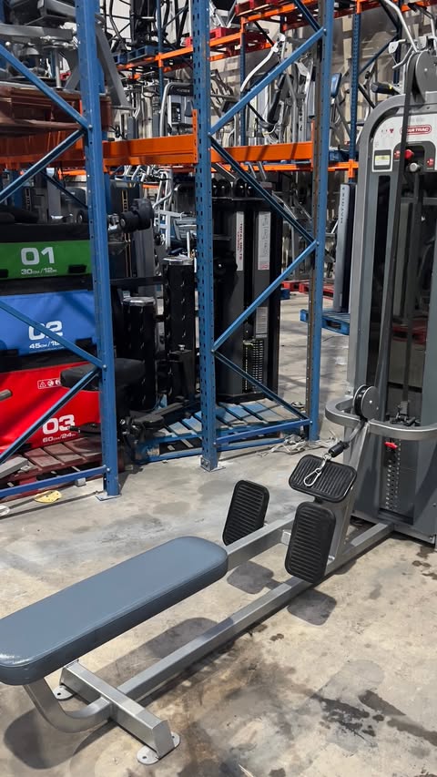 a well-equipped gym with various exercise equipment, including a pull-up bar and a weight rack.