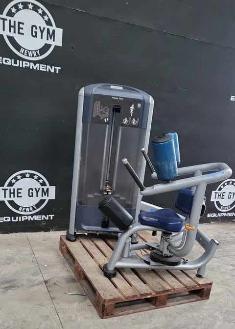 a weight training machine, specifically a chest press, placed on a wooden pallet in front of a gym equipment wall.
